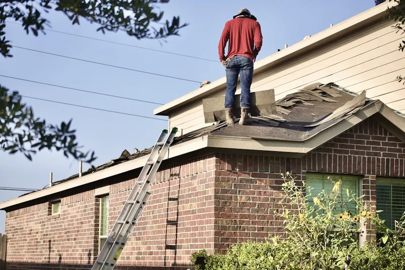 Professional roofer working on a residential roof in Kentwood